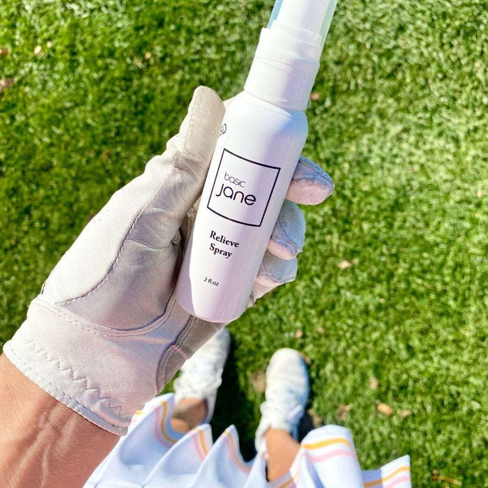 Relieve Pain CBD Spray in golfers hand. Point and spray pain sprays for relief.  CBD products commonly used by seniors and athletes